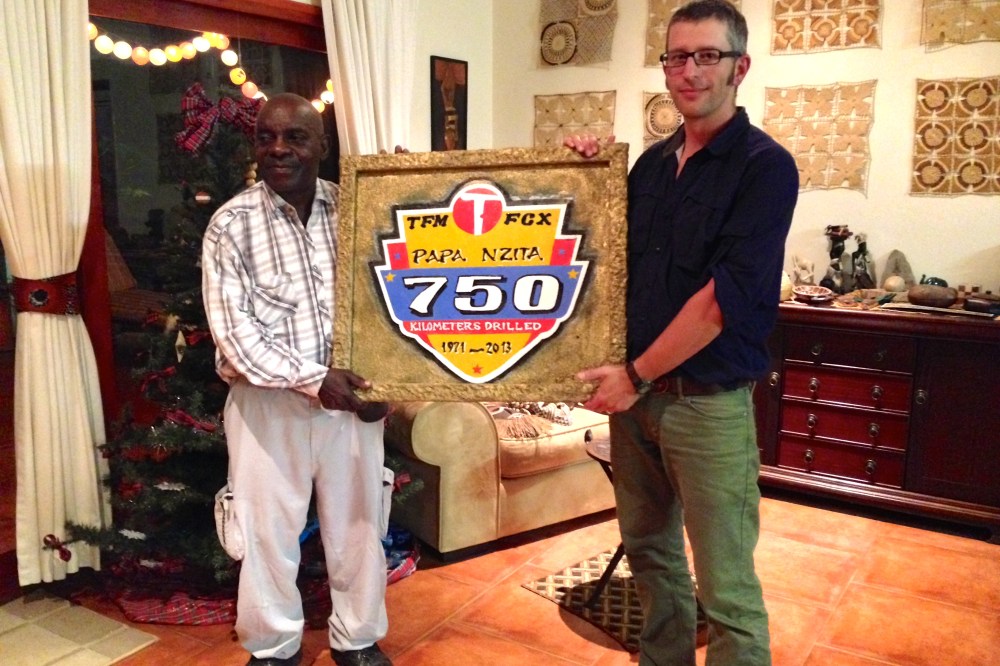 (December) Celebrating Papa Nzita's birthday at our place, with a plaque Seb had made commemorating his lifetime achievement in exploration drilling