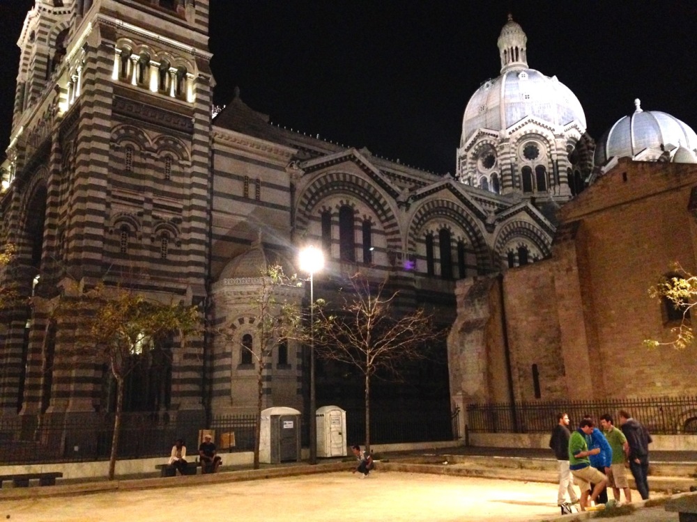 playing pétanque by night at the Marseille Cathedral