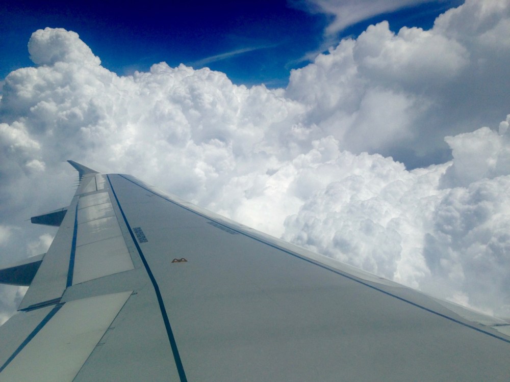 Sitting on the wing, nice -- safest place. Going around a storm while trilingual announcements tell us to expect turbulence.